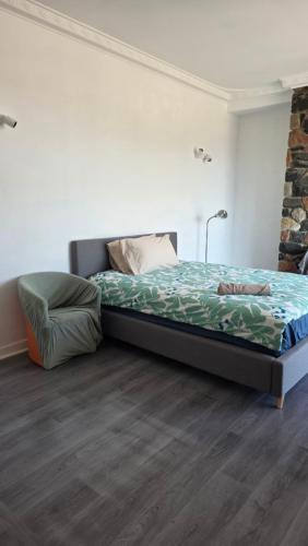 a bedroom with a bed and a chair in it at room near train station and airport in Perth