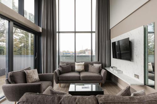 a living room with two couches and a tv at Skyline Serenity Ultra Luxury apartments by Luxus in Belfast