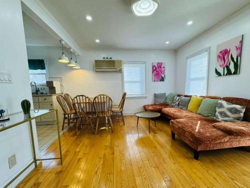 a living room with a couch and a table at Family Home near NY Beach - Private Workspace in Glen Head