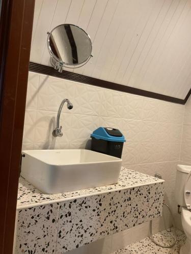a bathroom with a sink and a mirror and a toilet at Mountain Deer Resort & Camping in Ban Mung
