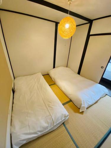 Ένα ή περισσότερα κρεβάτια σε δωμάτιο στο TAKEITEI Japanese-style lodge