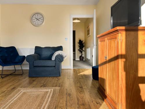 a living room with a couch and a television at Marina Escape in Swansea