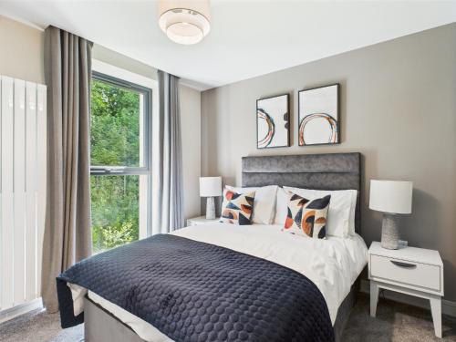a bedroom with a large bed and a window at Skyline Serenity Ultra Luxury apartments by Luxus in Belfast