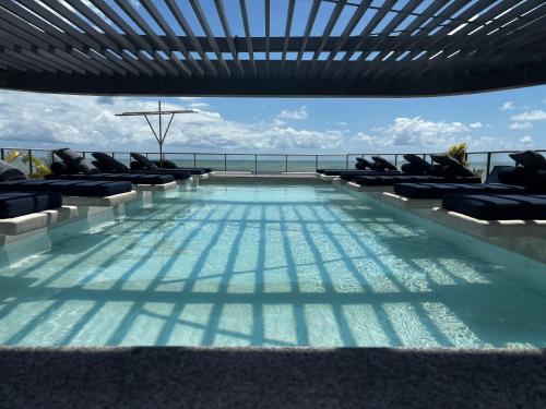 a swimming pool on the roof of a building at Setai, Aquamaris- pé na areia in João Pessoa