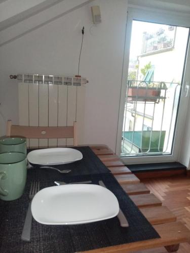 a room with two white toilets on a wooden floor at bed and breakfast La Terrazza in Genoa