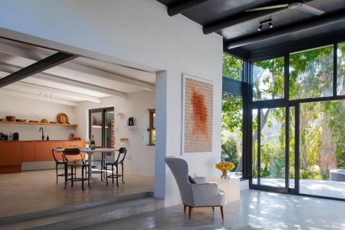 a kitchen and dining room with a table and chairs at Aarde in Barrydale