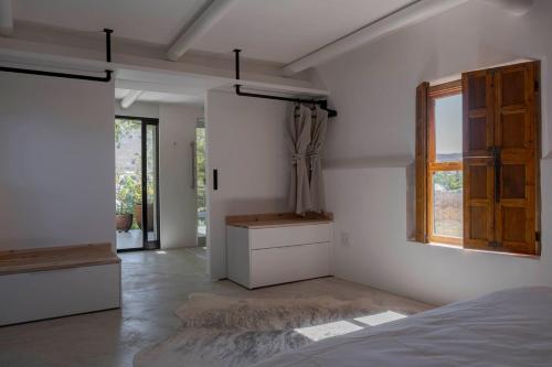 a bedroom with a bed and a window at Aarde in Barrydale