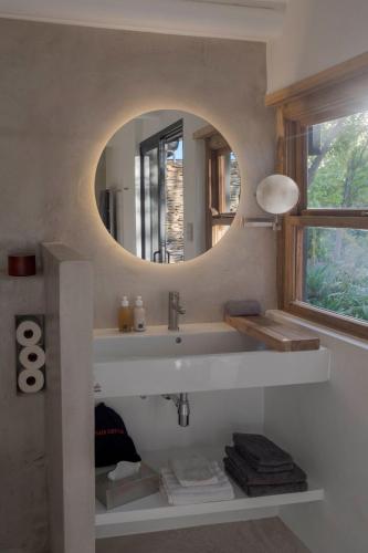 a bathroom with a sink and a mirror at Aarde in Barrydale