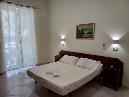 Postel nebo postele na pokoji v ubytování Aparthotel Napoli Railway