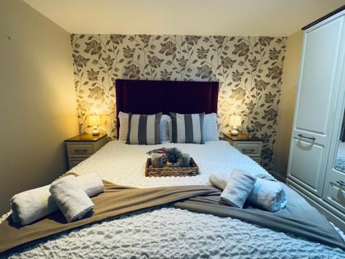 a bedroom with a large bed with pillows at Pears Suite - 1 Bedroom - Sleeps 2 in Whitehaven