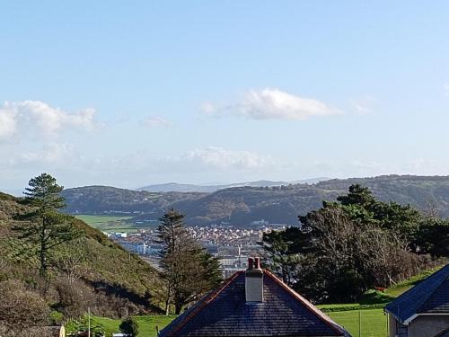 a view of a city from a roof of a house at Copper Mine Cottage in Llandudno