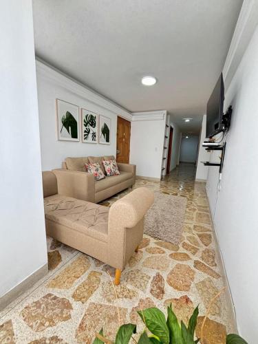 a living room with a couch and a tv at Unbeatable location in Medellín in Medellín