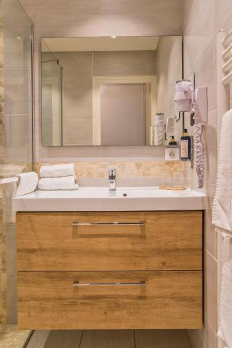 a bathroom with a sink and a mirror at Hôtel BO & MIA in La Baule