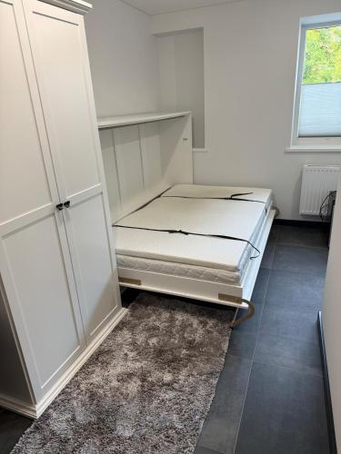 a bedroom with a bed and a cabinet and a rug at Flat In the heart of Kaunas city center in Kaunas