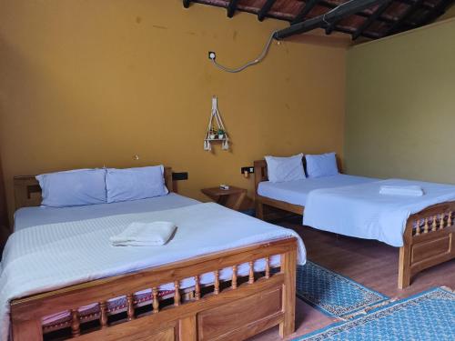 two beds in a room at La Bella Hotels and Resorts in Purulia