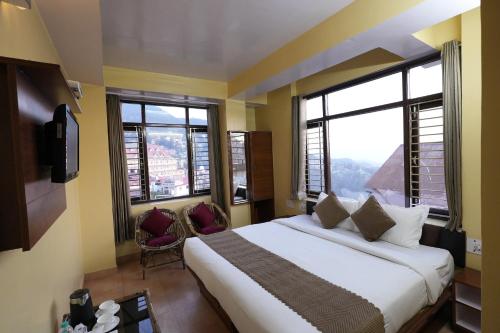 a bedroom with a large bed and two windows at Harmony Sentiments in Jāmb