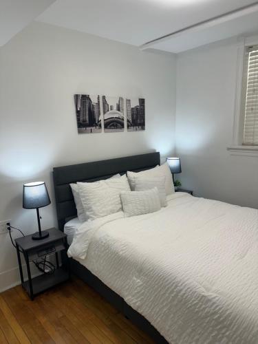 a bedroom with a large bed with white sheets at The Lyons' Lair in Chicago