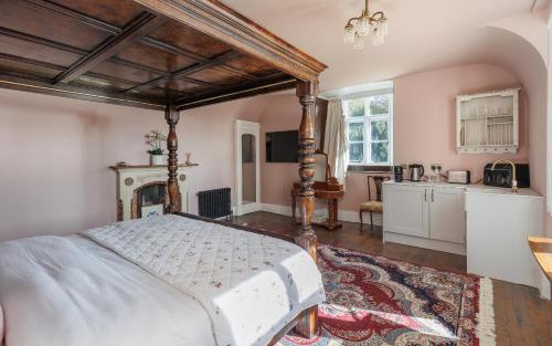 a bedroom with a large bed and a kitchen at East Dene Estate in Isle of Wight
