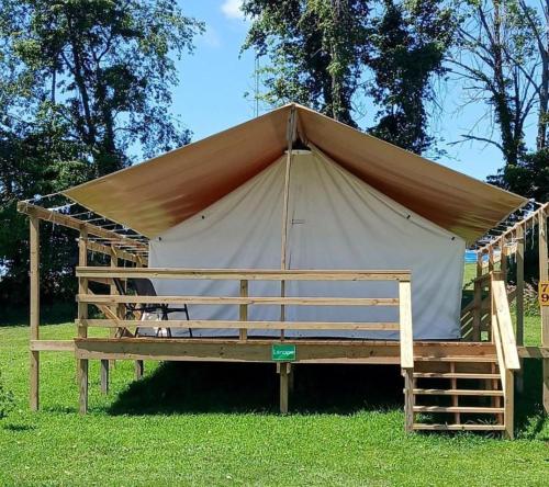 a large tent in the grass in a field at Cozy Tented Cabin with Fire Pit and Barbecue in Logan, Ohio in Logan