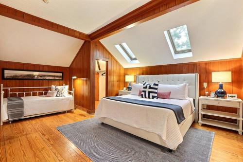 a bedroom with a bed and a mirror and skylights at Captain's Quarters on Lafayette in Savannah