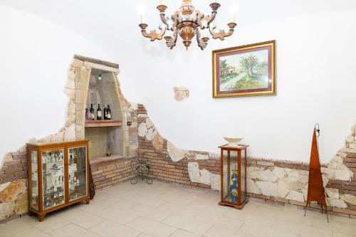 a room with a chandelier and a brick wall at View, Terrace & Comfort in Sant'Agata de' Goti in SantʼAgata deʼ Goti