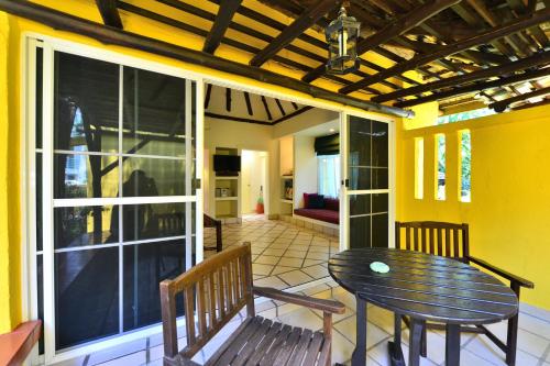 a porch with a wooden table and chairs on a house at Supatra Hua Hin Resort in Hua Hin