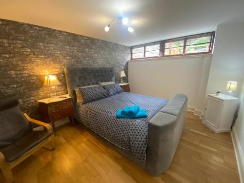 a bedroom with a bed with a blue pillow on it at Bruce on the Row-Historic Elegance near Edinburgh in Dunfermline