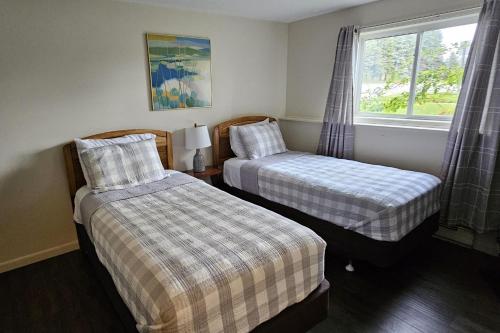 two beds in a room with a window at Sugar Baby (B6) in Cedar