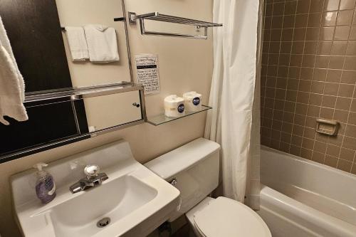 a bathroom with a white toilet and a sink at Sugar Baby (B6) in Cedar