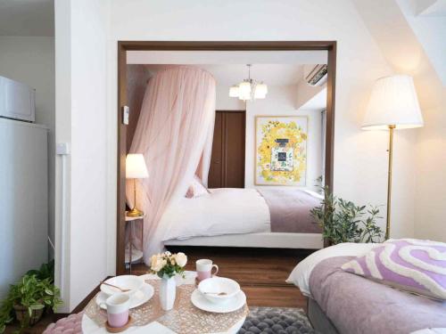a bedroom with two beds and a table and a mirror at MY STORY Cute 605ｰ瓦町駅徒歩6分 in Takamatsu
