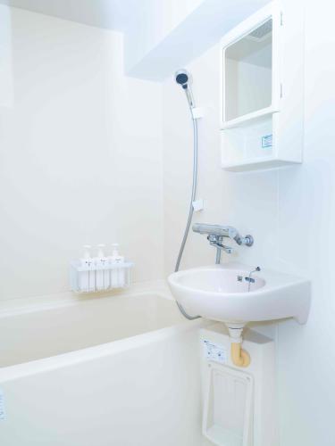 a white bathroom with a sink and a mirror at MY STORY Cute 605ｰ瓦町駅徒歩6分 in Takamatsu