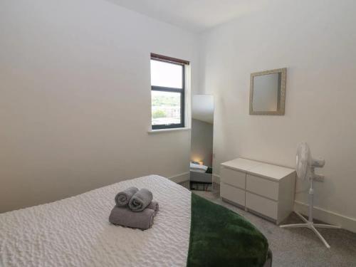 ein weißes Schlafzimmer mit einem Bett und einem Fenster in der Unterkunft Harbourside Apartment - 1 Bedroom - Sleeps 2 in Whitehaven