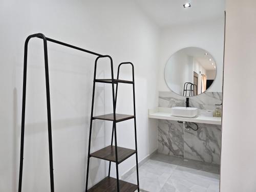 a bathroom with a shelf and a mirror at View Theras Hotel in Doradal