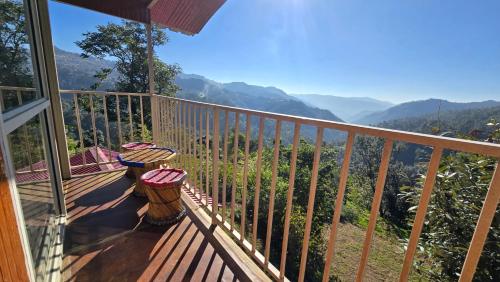 a balcony with a view of the mountains at TREE HOUSE BY THE CITY ESCAPE in Shimla