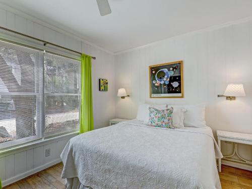 a bedroom with a bed and a large window at Coops Retreat Unit B in Tybee Island