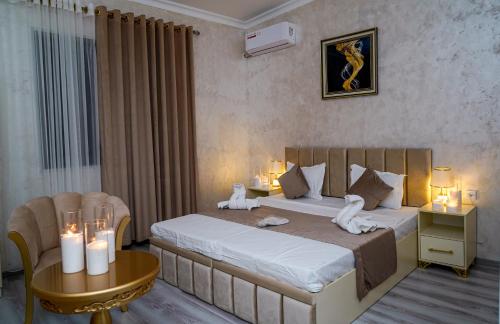 a bedroom with a bed and a table with candles at Astoria Inn in Toshkent-Passajir Bekati