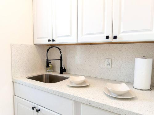 a kitchen counter with white cabinets and a sink at Exclusive Studio Steps To The Beach With Pool in Hollywood Beach