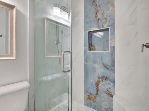 a shower with a glass door in a bathroom at Oceanview Bliss in Tybee Island