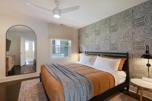 a bedroom with a large bed and a mirror at Harmony House in Nashville