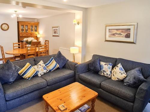 a living room with a couch and a table at Joan's Cottage in Braithwaite