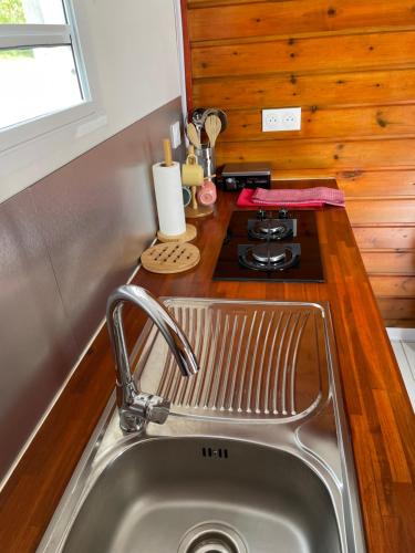 a kitchen with a sink and a stove at Les gîtes Lanmou 1 in La Désirade