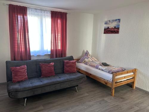 a living room with a black couch and a wooden table at Wohnung VS in Villingen-Schwenningen