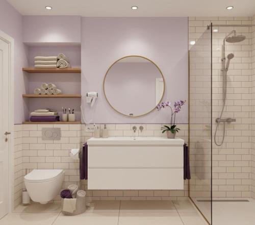 a bathroom with a toilet and a sink and a mirror at La-Sa Apart Hotel in Icmeler