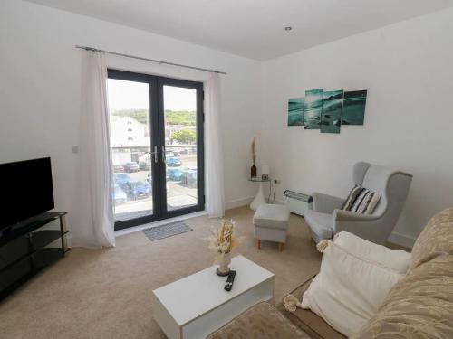 a living room with a couch and a tv at Sea View Apartment - 2 Bedrooms - Sleeps 4 in Whitehaven