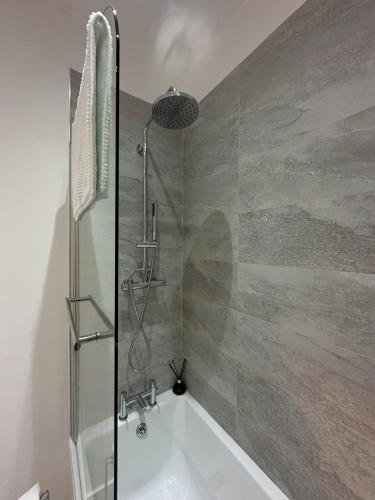 a bathroom with a shower and a bath tub at Sea View Apartment - 2 Bedrooms - Sleeps 4 in Whitehaven