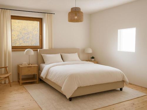 a bedroom with a bed with two night stands and a window at Tirola Hütte in Alpbach