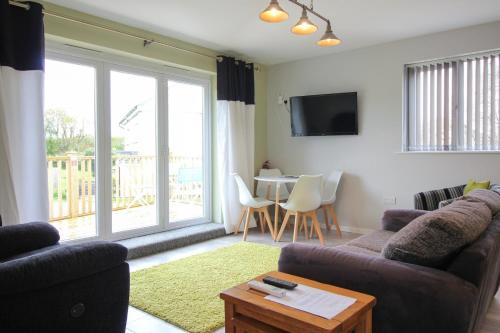 a living room with a couch and a table at Gwel An Koos in Bodmin