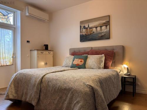 een slaapkamer met een bed met een deken erop bij Free Parking l Electric Chimney l Everything nearby in Pärnu