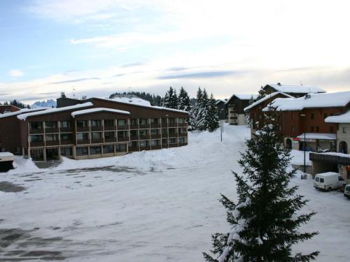 ein schneebedeckter Parkplatz vor einem Hotel in der Unterkunft Appartement 2 pièces, 6 pers, au pied des pistes, Le Praz de Lys - FR-1-815-8 in Le Praz de Lys