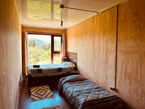 a small room with a bed and a window at Casa con vista a los volcanes y Lago Llanquihue in Puerto Varas